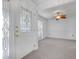 Bright foyer featuring a decorative glass front door, neutral carpet and a view of the formal living area at 5202 Greenway Drive, Orlando, FL 32819