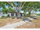 Beautiful single-story home with mature landscaping creating a serene setting and a well-kept lawn at 5202 Greenway Drive, Orlando, FL 32819