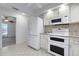 Bright kitchen features a white refrigerator, white oven, and tile flooring at 5202 Greenway Drive, Orlando, FL 32819