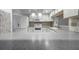 Bright kitchen features updated appliances, white cabinetry and speckled countertops at 5202 Greenway Drive, Orlando, FL 32819
