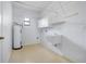 Functional laundry room with a utility sink, water heater, and ample storage space at 5202 Greenway Drive, Orlando, FL 32819