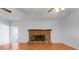 Living room features hardwood floors and a brick fireplace at 5202 Greenway Drive, Orlando, FL 32819