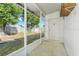 Enclosed patio featuring screening for pest-free outdoor living, transitioning to the backyard at 5202 Greenway Drive, Orlando, FL 32819