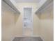 Spacious walk-in closet with shelving on both sides and an attached bathroom at 5202 Greenway Drive, Orlando, FL 32819
