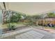 Covered patio with a neutral tile and a view into the tree-filled backyard at 5215 Ashwood Pl, Orlando, FL 32808