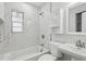 Bathroom featuring white tile surround, modern fixtures, and a well-lit vanity at 5215 Ashwood Pl, Orlando, FL 32808