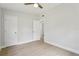 Bright bedroom with vinyl floors featuring two doors and a ceiling fan at 5215 Ashwood Pl, Orlando, FL 32808