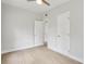 Bright bedroom with vinyl floors featuring two doors and a ceiling fan at 5215 Ashwood Pl, Orlando, FL 32808