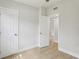 Bright bedroom with vinyl floors featuring two doors and a ceiling fan at 5215 Ashwood Pl, Orlando, FL 32808