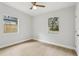 This bedroom features two windows with lots of light and vinyl flooring at 5215 Ashwood Pl, Orlando, FL 32808