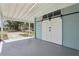 Attached carport featuring large barn doors and plenty of storage at 5215 Ashwood Pl, Orlando, FL 32808