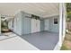 Exterior shot of a light blue house with large barn doors on the carport at 5215 Ashwood Pl, Orlando, FL 32808