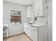 Kitchen featuring white cabinets, countertops, stainless steel appliances, and natural light at 5215 Ashwood Pl, Orlando, FL 32808