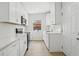 Well-lit kitchen featuring white cabinets, stainless appliances, and ample counter space at 5215 Ashwood Pl, Orlando, FL 32808