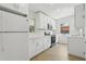 Bright kitchen featuring white cabinets, countertops, and modern appliances at 5215 Ashwood Pl, Orlando, FL 32808