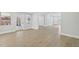 Bright living room featuring light, wood-look floors and a large window for plenty of natural light at 5215 Ashwood Pl, Orlando, FL 32808