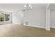 Light-filled living room featuring neutral walls, wood-look flooring, and contemporary lighting at 5215 Ashwood Pl, Orlando, FL 32808