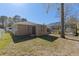 Fenced backyard with a screened in pool and a small utility shed at 5347 Pecan Rd, Ocala, FL 34472