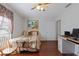 Bedroom with wood floors, closet, and art piece above the bed at 5347 Pecan Rd, Ocala, FL 34472