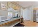 Kitchen counterspace with microwave, stainless steel fridge, and kitchen window at 5347 Pecan Rd, Ocala, FL 34472