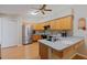 Kitchen with wood cabinets, stainless steel refrigerator, and a ceiling fan at 5347 Pecan Rd, Ocala, FL 34472