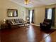 Inviting living room with hardwood floors, natural light, and comfortable seating at 5347 Pecan Rd, Ocala, FL 34472