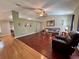 Open-concept living room with hardwood floors, neutral colors, and comfortable furniture at 5347 Pecan Rd, Ocala, FL 34472