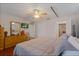 Main bedroom with wood floors, ceiling fan, and bathroom and closet doors at 5347 Pecan Rd, Ocala, FL 34472