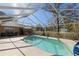 Sparkling screened-in pool area provides a private oasis for relaxation and recreation in a lush, tropical setting at 5347 Pecan Rd, Ocala, FL 34472
