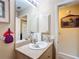 Well-lit bathroom equipped with a sink, a large mirror, and clean neutral decor at 5361 Se 92Nd St, Ocala, FL 34480