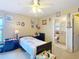Bedroom with a ceiling fan, decorated walls, and a view into the adjacent bathroom at 5361 Se 92Nd St, Ocala, FL 34480