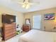 Cozy bedroom featuring a ceiling fan, natural light, and comfortable furnishings at 5361 Se 92Nd St, Ocala, FL 34480