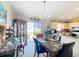 Dining area with a chandelier, table, chairs and view to the kitchen and patio at 5361 Se 92Nd St, Ocala, FL 34480