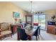 Bright dining room with a chandelier, marble table and sliding glass doors leading to the backyard at 5361 Se 92Nd St, Ocala, FL 34480