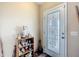 Entryway featuring a decorative glass door and adjacent display shelves at 5361 Se 92Nd St, Ocala, FL 34480