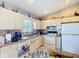 Well-lit kitchen featuring white cabinets, modern appliances, and ample counter space at 5361 Se 92Nd St, Ocala, FL 34480