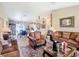 Comfortable living room showcasing ample seating, a large rug, and a view into the dining and kitchen areas at 5361 Se 92Nd St, Ocala, FL 34480