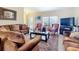 Cozy living room featuring plush sofas, a large area rug, and a bright window at 5361 Se 92Nd St, Ocala, FL 34480