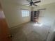 Bedroom with outdated ceiling fan with two windows, shelving, and stained floors needing renovation at 5401 Bobby St, Orlando, FL 32807