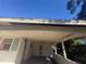 Covered carport featuring a weathered ceiling, exposed eaves, and peeling paint at 5401 Bobby St, Orlando, FL 32807