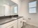 Modern bathroom featuring a dark countertop, white cabinets, and a toilet at 5655 Stephens Rd, St Cloud, FL 34771