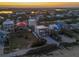 Breathtaking aerial perspective of houses nestled between the peaceful beach and river, highlighting an idyllic location at 6480 S Atlantic Ave, New Smyrna Beach, FL 32169