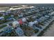 Aerial view showcases vibrant neighborhood with marsh views; beachfront houses offer a perfect coastal living setting at 6480 S Atlantic Ave, New Smyrna Beach, FL 32169