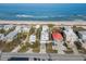 Scenic aerial shot of beach houses with direct ocean access, featuring a red-roofed house at 6480 S Atlantic Ave, New Smyrna Beach, FL 32169