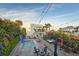 Backyard with pool, wooden deck, lush tropical landscaping and string lights at 6480 S Atlantic Ave, New Smyrna Beach, FL 32169