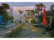 Backyard with a pool, stone pathway, manicured landscaping, and an exterior staircase at 6480 S Atlantic Ave, New Smyrna Beach, FL 32169