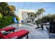 Beautiful backyard featuring a pool, a slide, lush tropical landscaping, and modern deck furniture at 6480 S Atlantic Ave, New Smyrna Beach, FL 32169