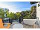 Outdoor balcony featuring a relaxing soaking tub, seating, and lush tropical foliage at 6480 S Atlantic Ave, New Smyrna Beach, FL 32169