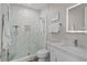Modern bathroom featuring a glass enclosed shower and marble countertops at 6480 S Atlantic Ave, New Smyrna Beach, FL 32169