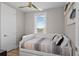 Cozy bedroom with daybed, white trim, and a ceiling fan at 6480 S Atlantic Ave, New Smyrna Beach, FL 32169